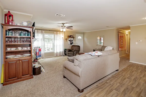 a living room with furniture a fireplace and gym equipment