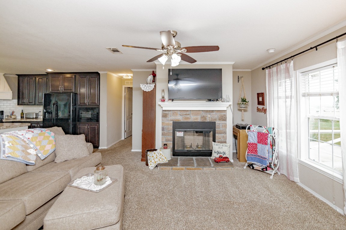1891 Dworaczyk Road Yorktown, TX 78164 - Photo 22 of 48 a living room with furniture a flat screen tv and a fireplace
