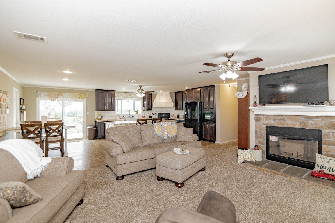 1891 Dworaczyk Road Yorktown, TX 78164 - Photo 23 of 48 a living room with furniture a fireplace and a flat screen tv