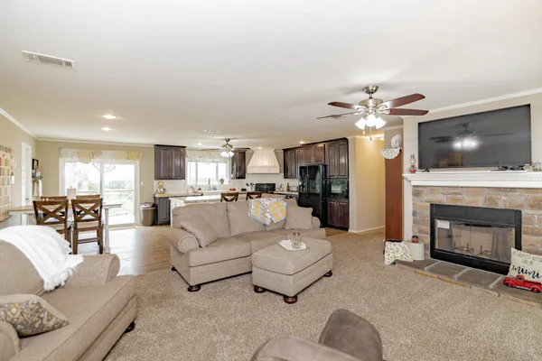 a living room with furniture a fireplace and a flat screen tv