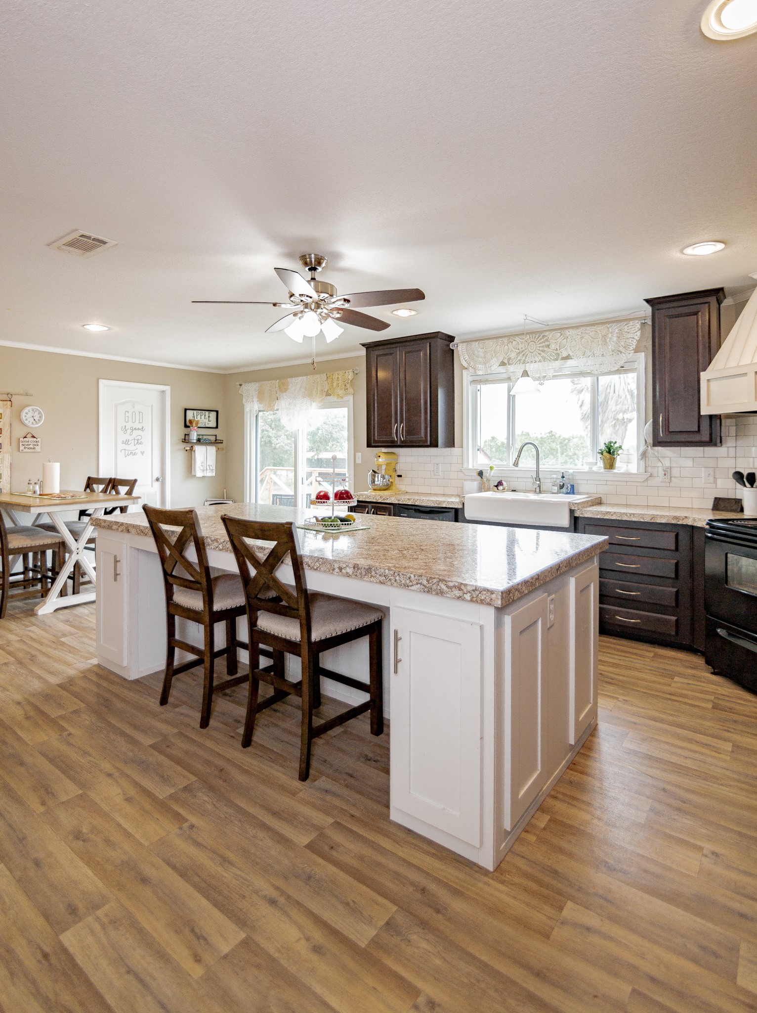 1891 Dworaczyk Road Yorktown, TX 78164 - Photo 25 of 48 a kitchen with stainless steel appliances granite countertop a table chairs sink and cabinets