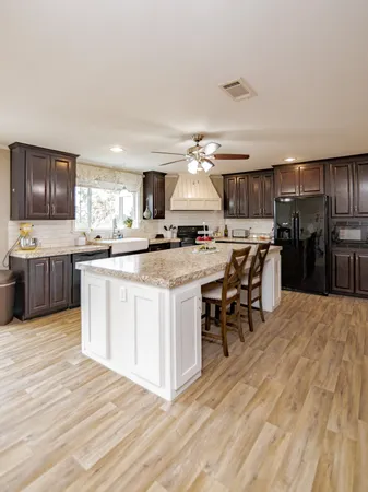 a kitchen with a sink a counter top space and stainless steel appliances