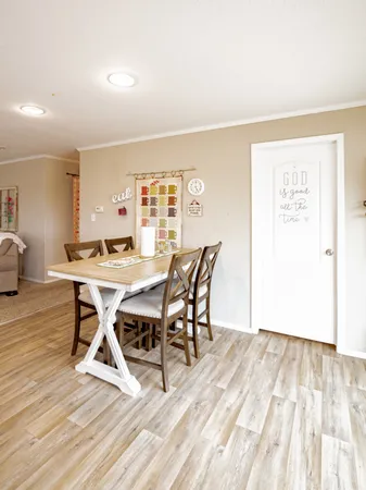 a dining room with a wooden table and chairs