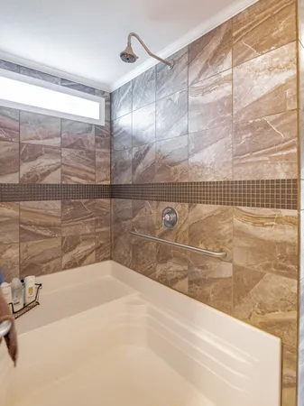 a bathroom with a bathtub and shower