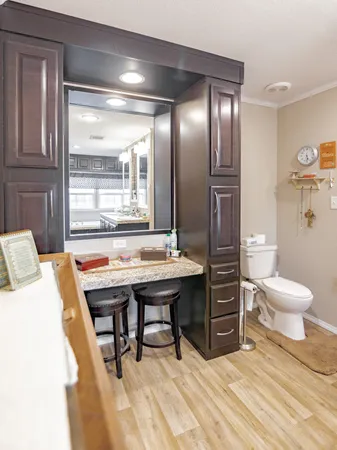 a view of a bathroom with a sink a toilet and a mirror