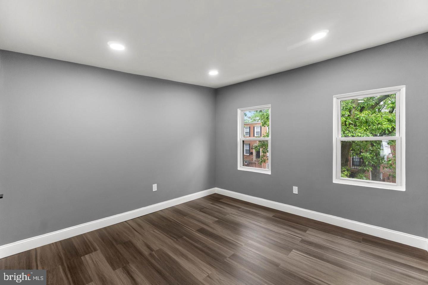 1524 Byrd Street Baltimore, MD 21230 - Photo 15 of 26 an empty room with wooden floor and windows