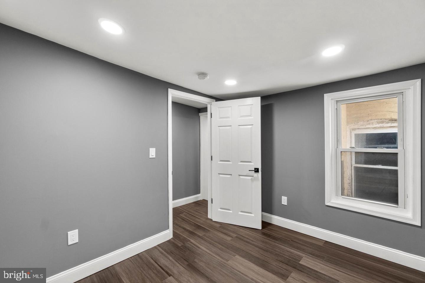 1524 Byrd Street Baltimore, MD 21230 - Photo 19 of 26 an empty room with wooden floor and windows