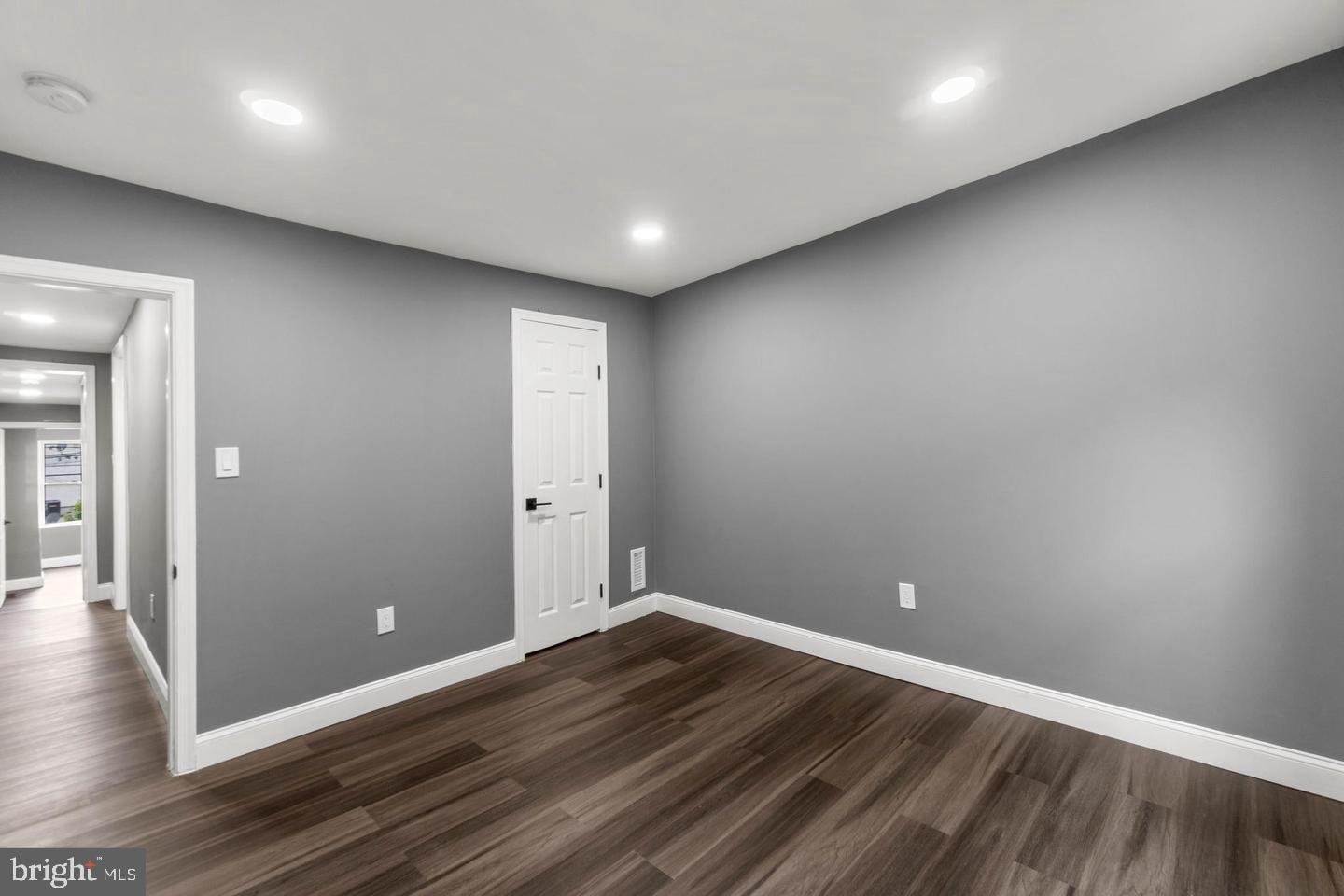 1524 Byrd Street Baltimore, MD 21230 - Photo 20 of 26 an empty room with wooden floor and entrance