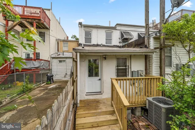 a front view of a house with wooden deck