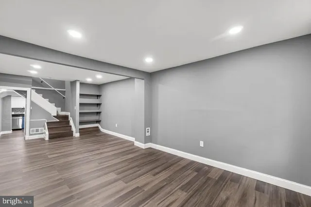 an empty room with wooden floor and closet