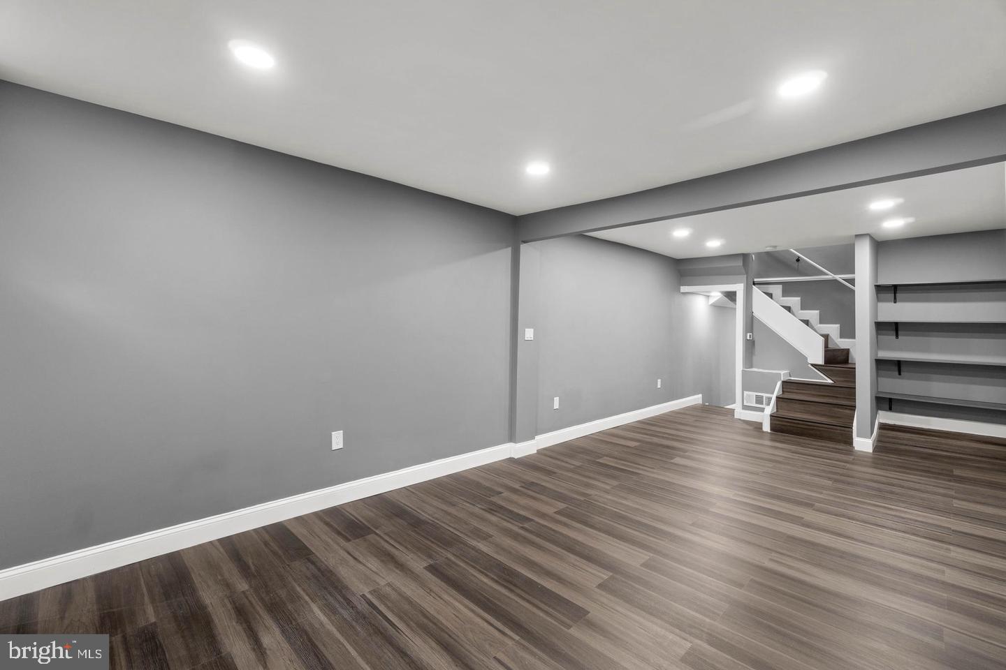1524 Byrd Street Baltimore, MD 21230 - Photo 4 of 26 a view of an empty room with wooden floor and stairs