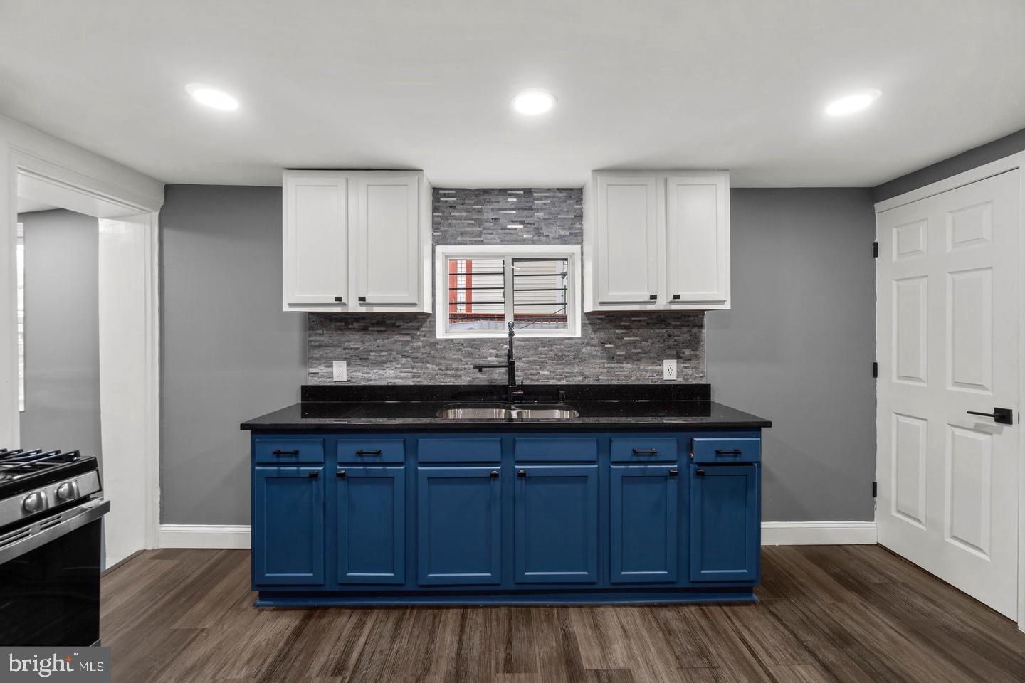 1524 Byrd Street Baltimore, MD 21230 - Photo 9 of 26 a kitchen with granite countertop wooden cabinets a sink and appliances