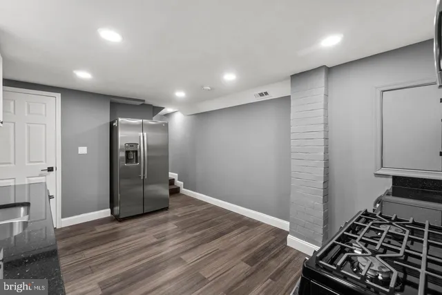 a kitchen with stainless steel appliances a refrigerator and a stove top oven