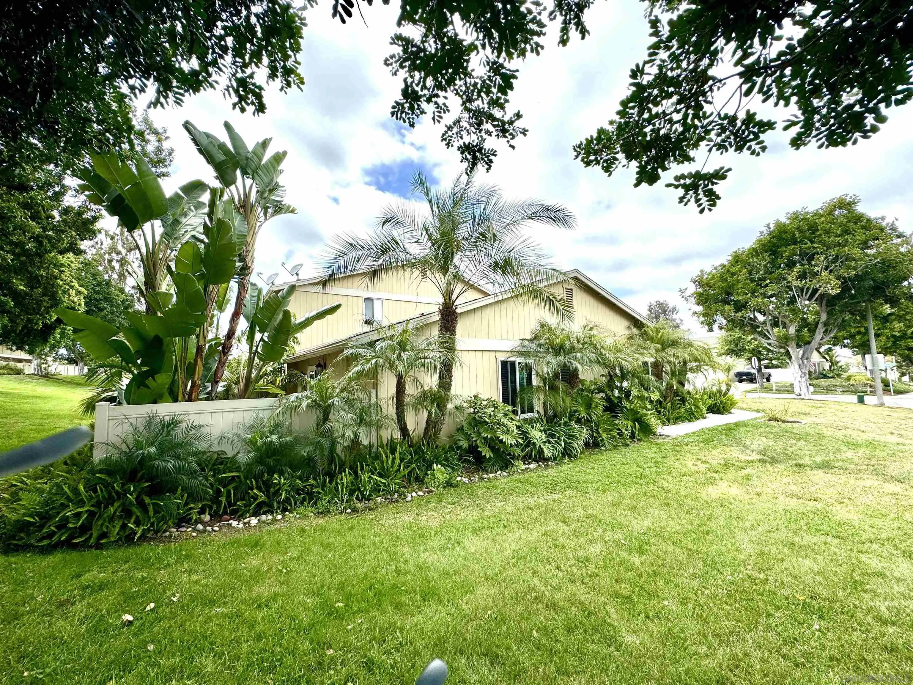a view of backyard of house with green space