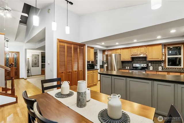 a kitchen with stainless steel appliances granite countertop a sink and a refrigerator