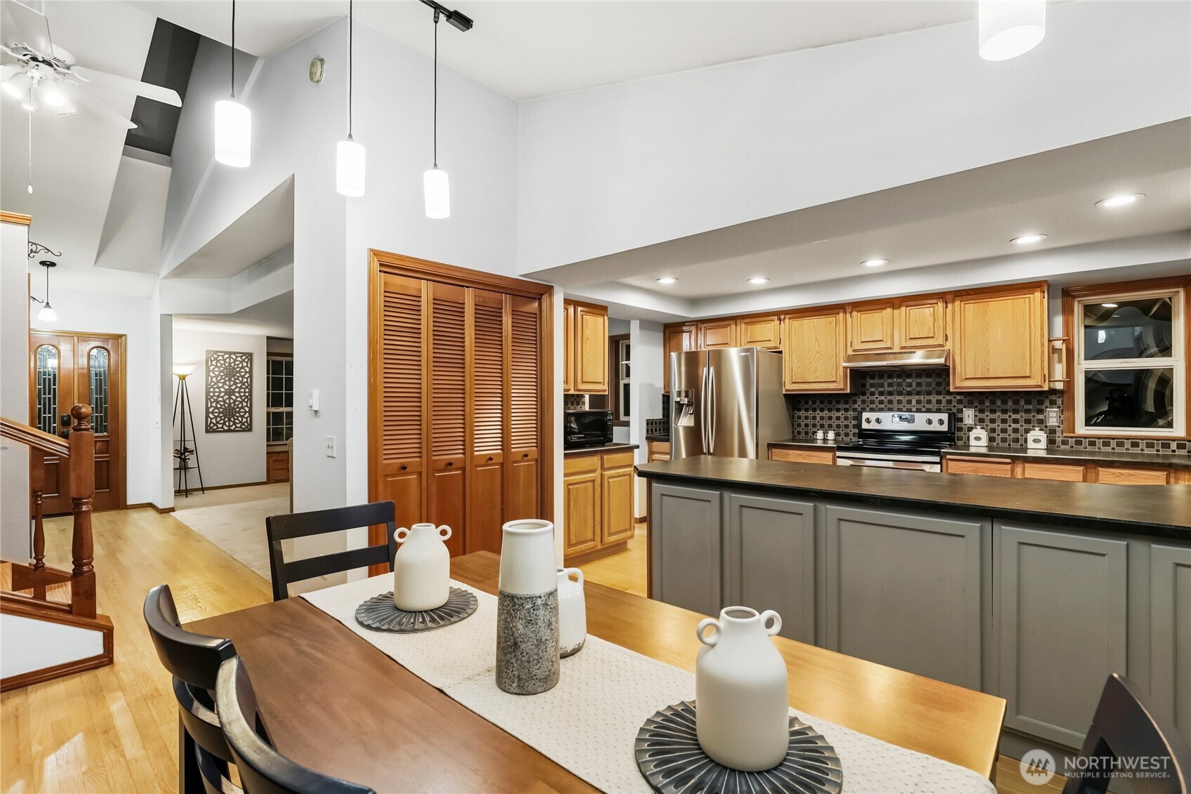 15121 Cedar Grove Road Northeast Poulsbo, WA 98370 - Photo 11 of 40 a kitchen with stainless steel appliances granite countertop a sink and a refrigerator