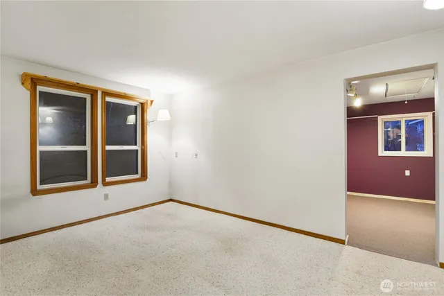 an empty room with windows and closet