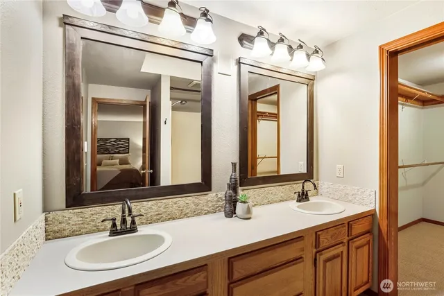 a bathroom with a sink double vanity and a mirror