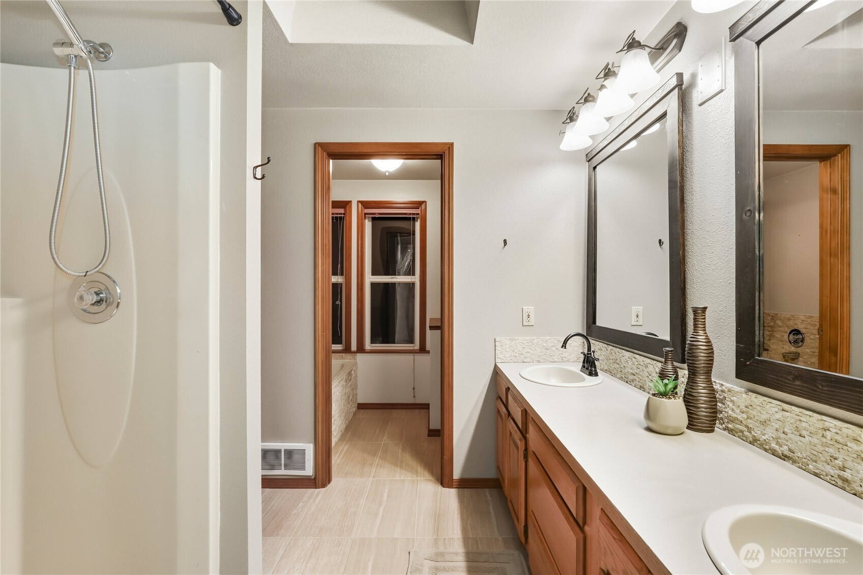 15121 Cedar Grove Road Northeast Poulsbo, WA 98370 - Photo 23 of 40 a en suite bathroom with a granite countertop sink and a mirror