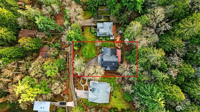 an aerial view of a house with a yard
