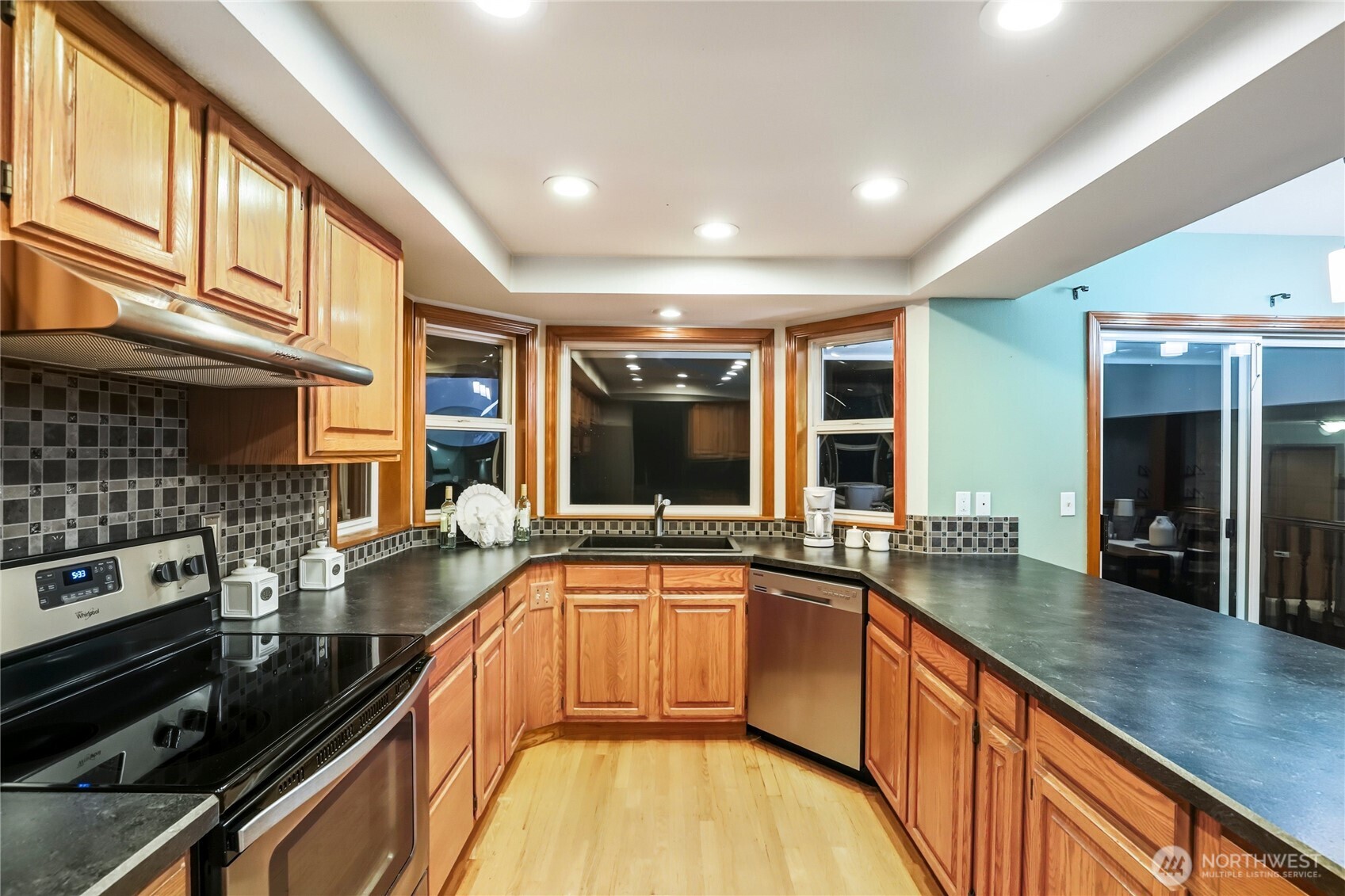 15121 Cedar Grove Road Northeast Poulsbo, WA 98370 - Photo 6 of 40 a large kitchen with stainless steel appliances granite countertop a lot of counter space and a sink