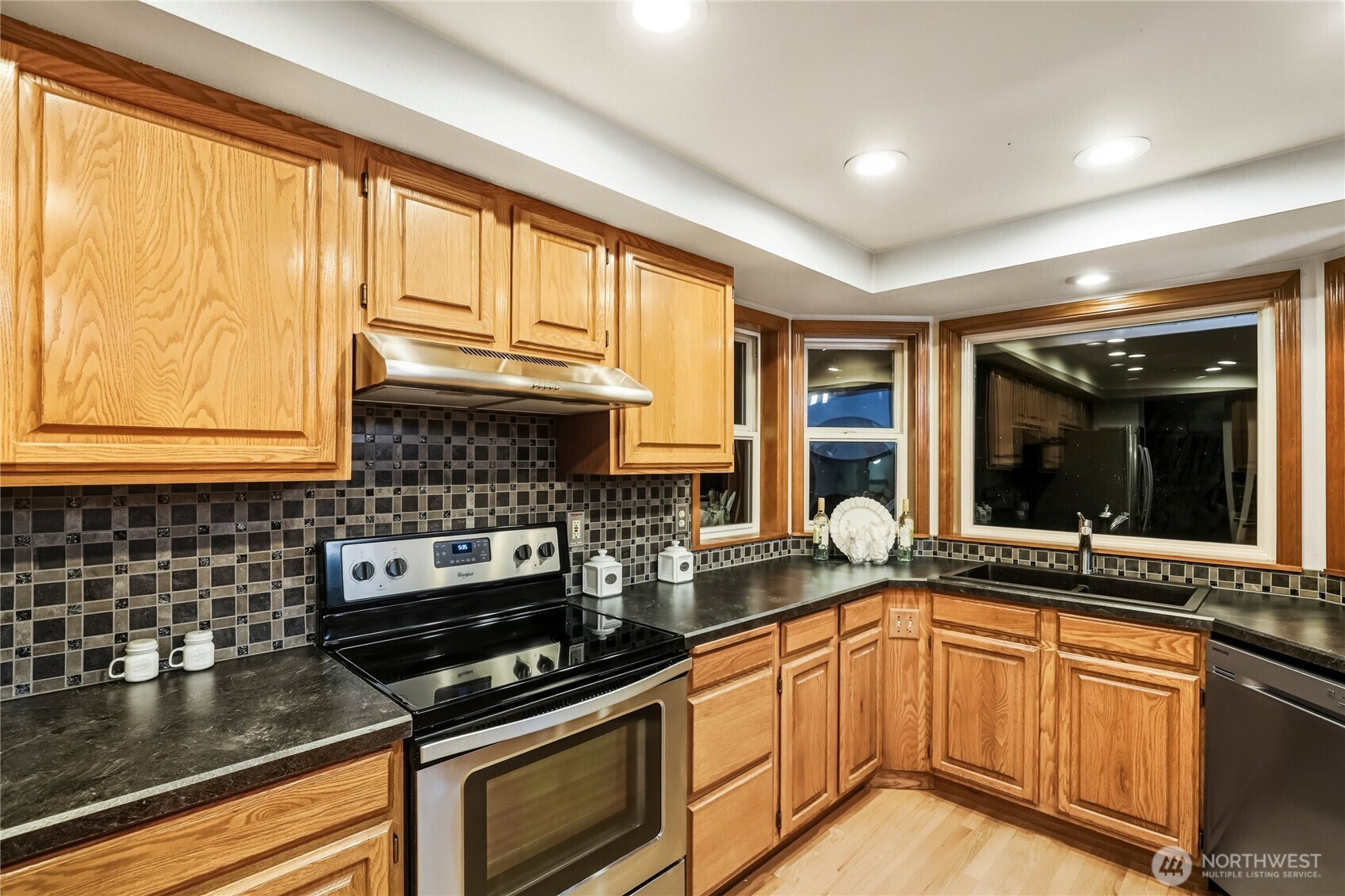 15121 Cedar Grove Road Northeast Poulsbo, WA 98370 - Photo 7 of 40 a kitchen with granite countertop a stove and a sink