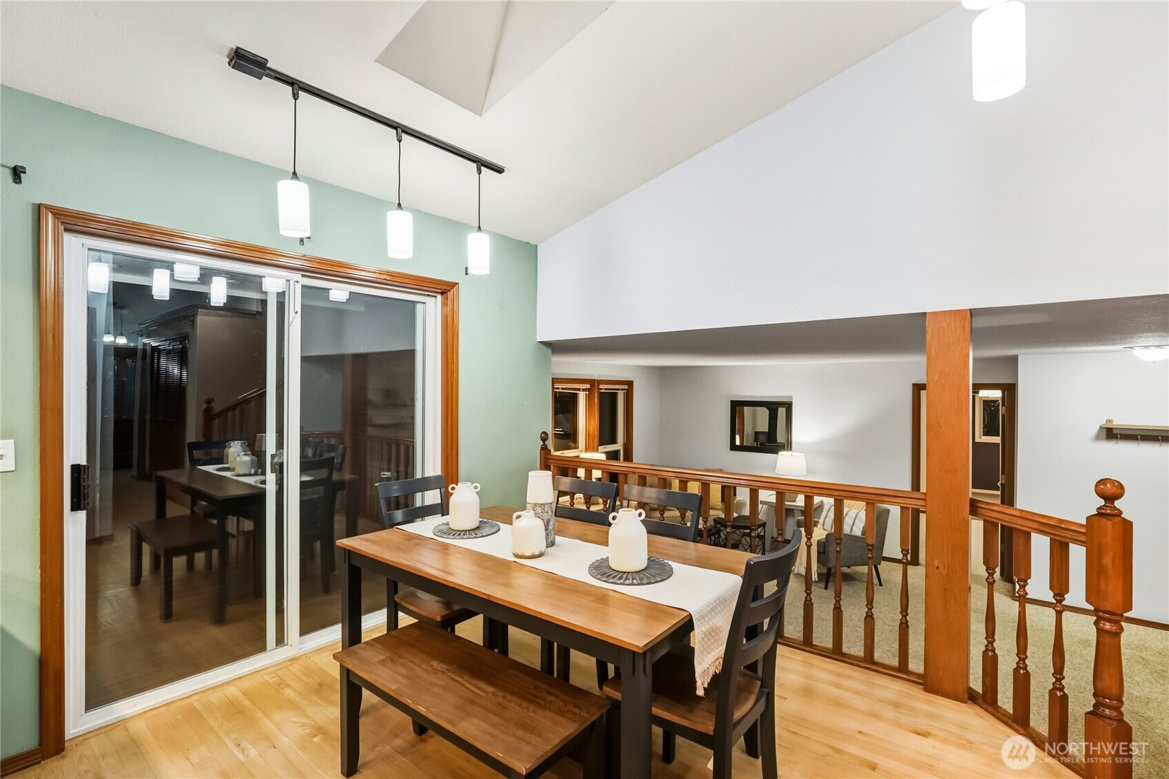 15121 Cedar Grove Road Northeast Poulsbo, WA 98370 - Photo 10 of 40 a dining room with furniture a chandelier and wooden floor