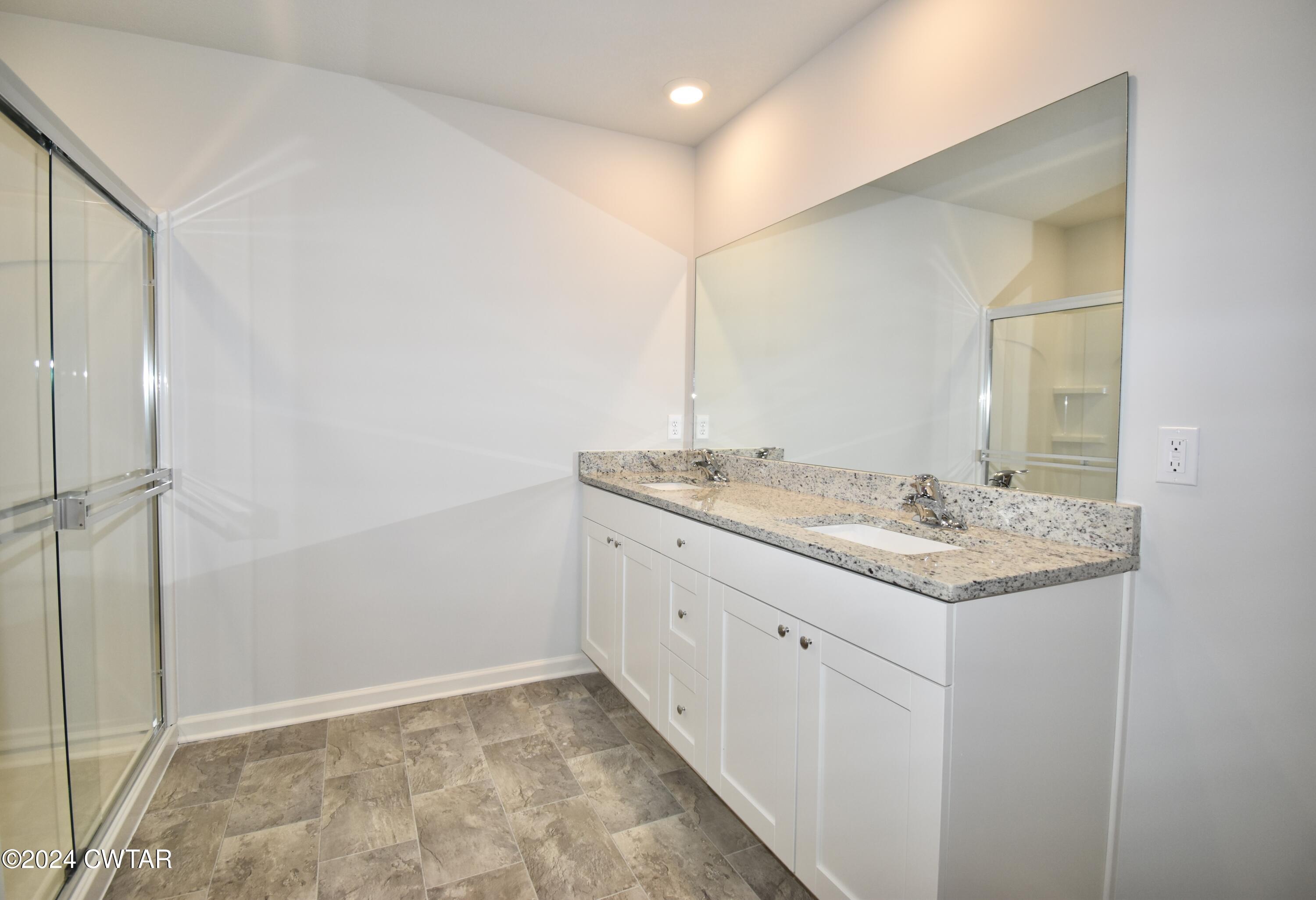 48 Vintage Grove Road Jackson, TN 38305 - Photo 12 of 19 a bathroom with a granite countertop sink and a mirror