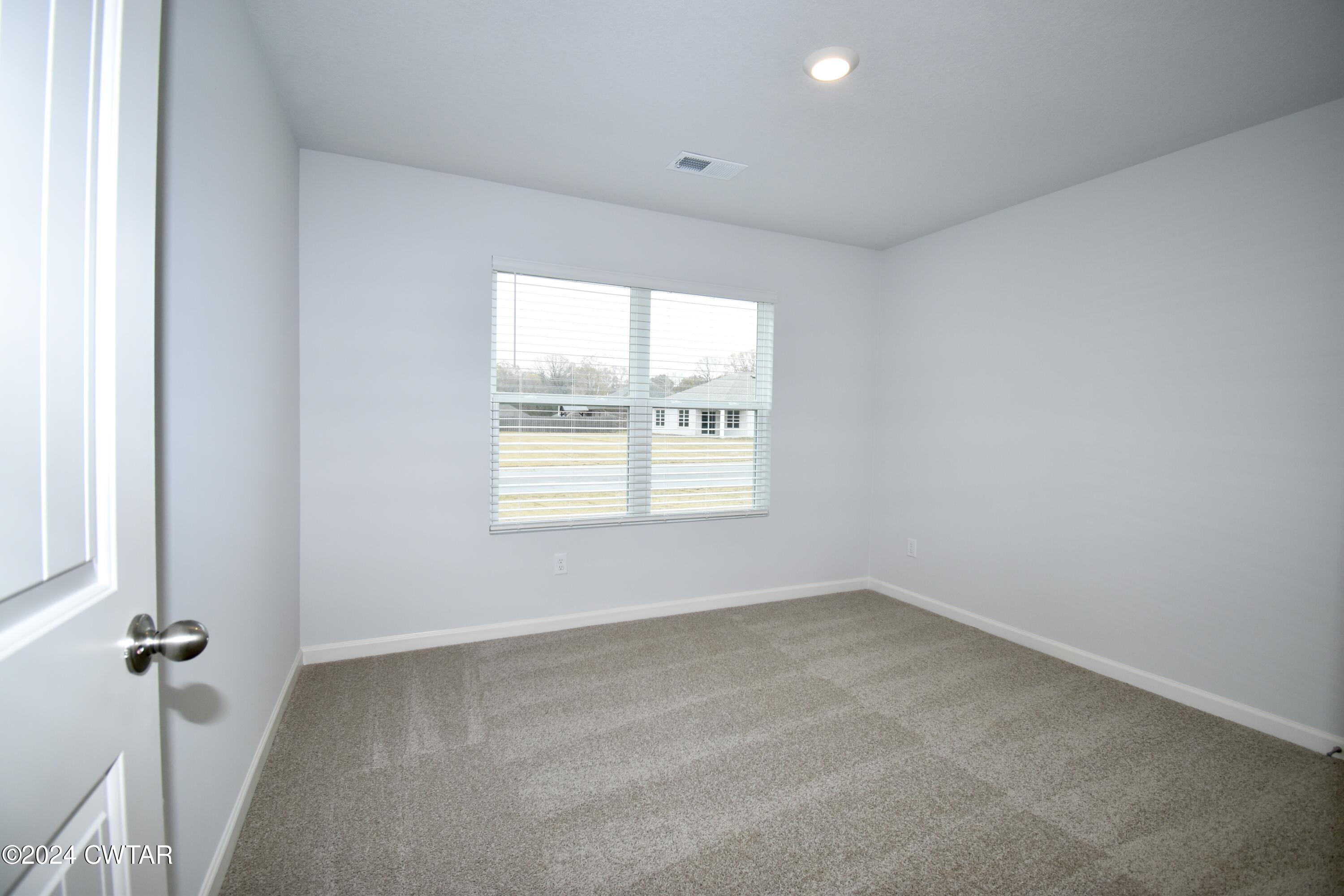 48 Vintage Grove Road Jackson, TN 38305 - Photo 14 of 19 an empty room with a window