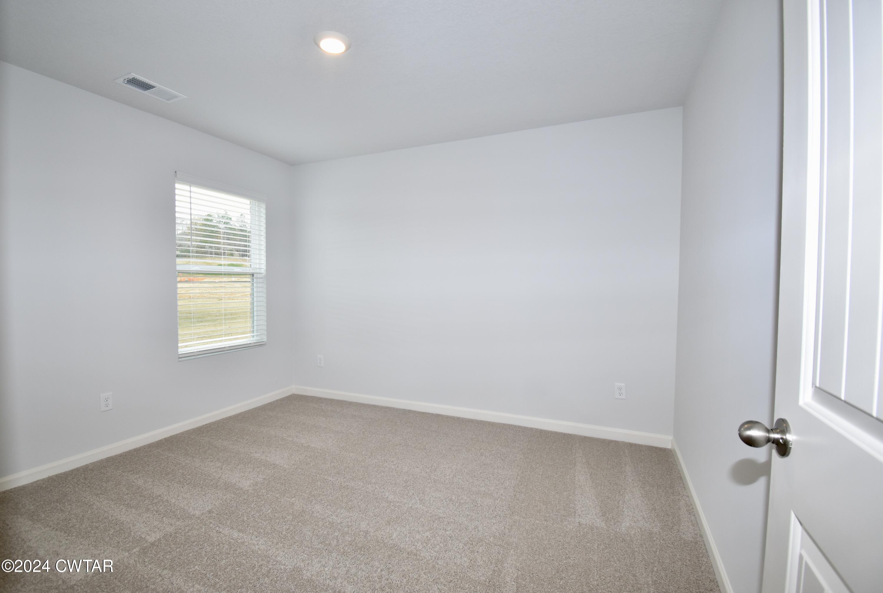 48 Vintage Grove Road Jackson, TN 38305 - Photo 16 of 19 an empty room with windows