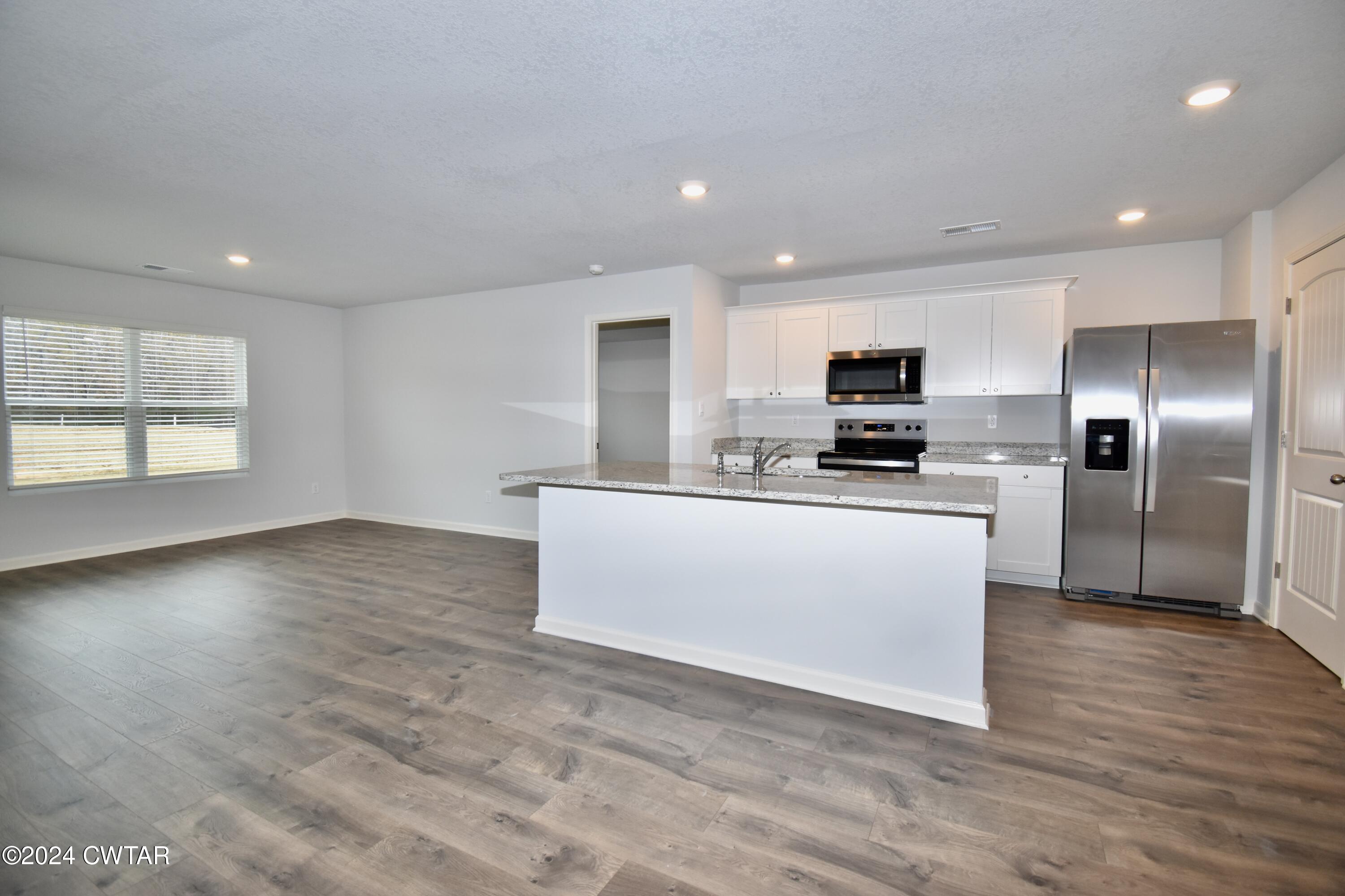 48 Vintage Grove Road Jackson, TN 38305 - Photo 3 of 19 a view of kitchen with granite countertop cabinets and refrigerator