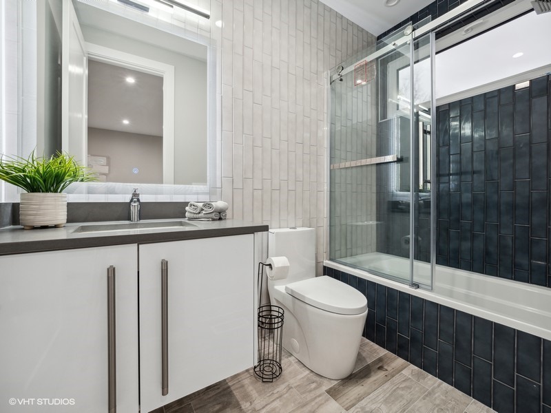 1341 Pfingsten Road Northbrook, IL 60062 - Photo 19 of 58 a bathroom with a granite countertop sink toilet and shower