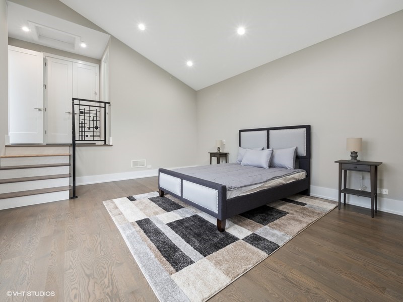 1341 Pfingsten Road Northbrook, IL 60062 - Photo 27 of 58 a spacious bedroom with a bed and a table in it