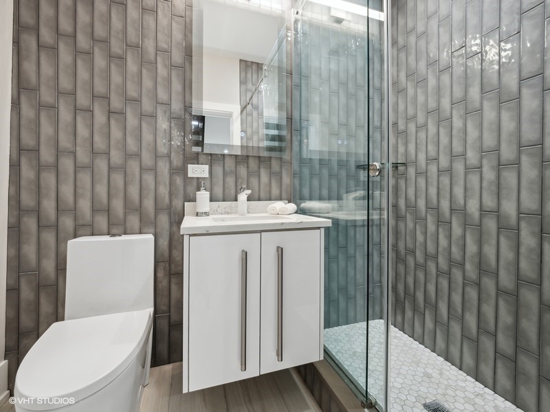 1341 Pfingsten Road Northbrook, IL 60062 - Photo 33 of 58 a bathroom with a sink a toilet and shower