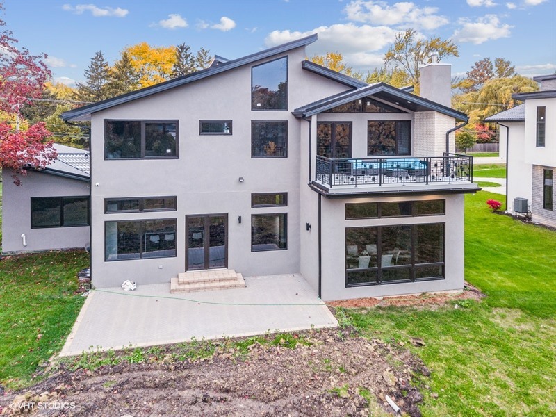 1341 Pfingsten Road Northbrook, IL 60062 - Photo 46 of 58 a front view of a house with a yard and garage