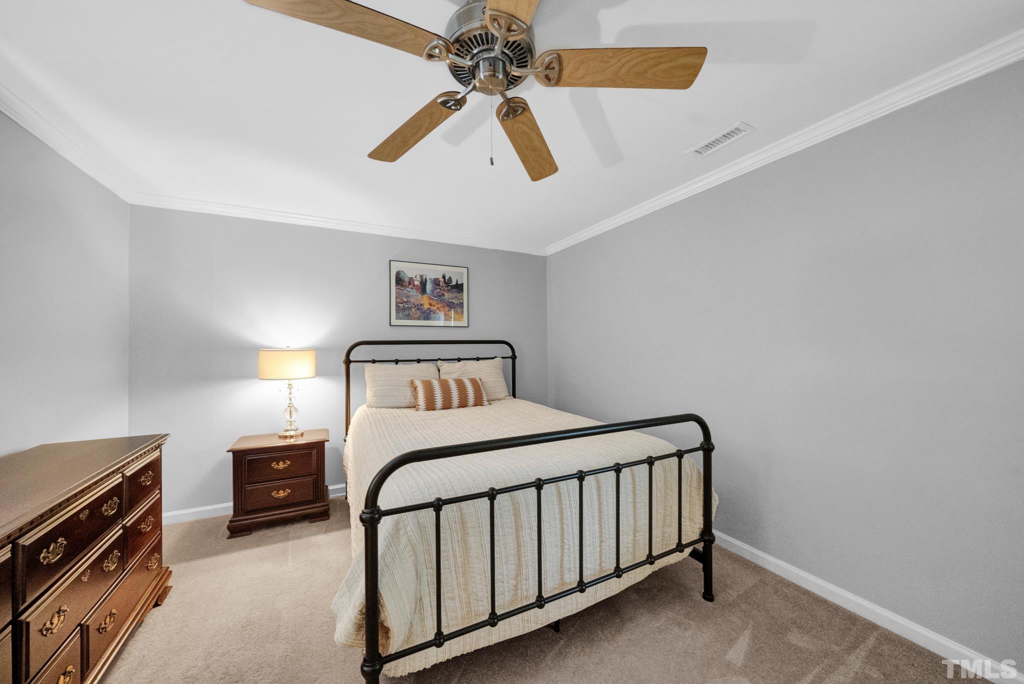 4650 Pine Trace Drive Raleigh, NC 27613 - Photo 14 of 26 a bedroom with a bed and a chandelier