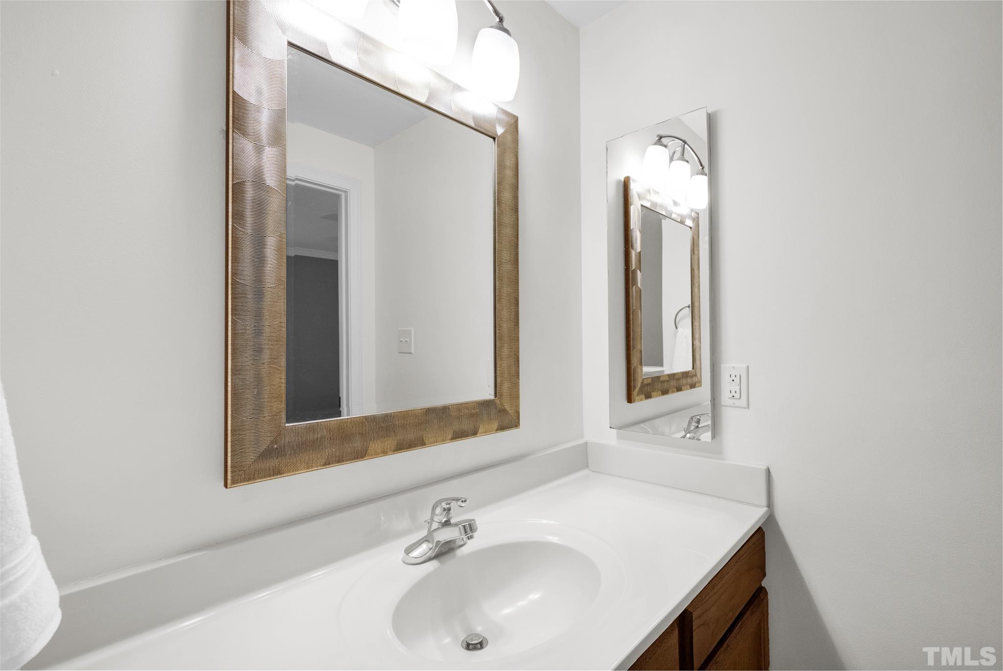 4650 Pine Trace Drive Raleigh, NC 27613 - Photo 17 of 26 a bathroom with a sink and a mirror
