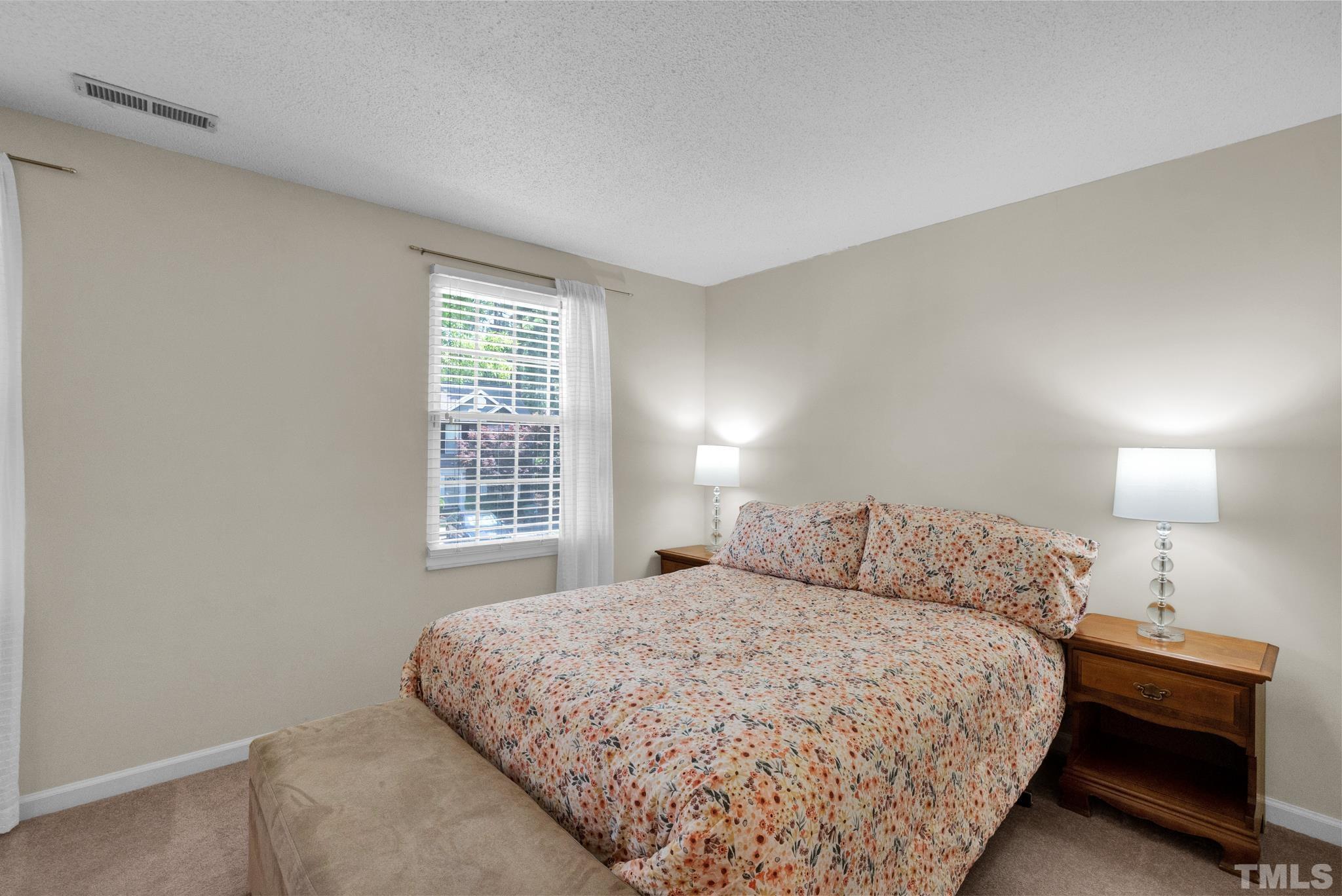 4650 Pine Trace Drive Raleigh, NC 27613 - Photo 19 of 26 a bedroom with a bed and a window