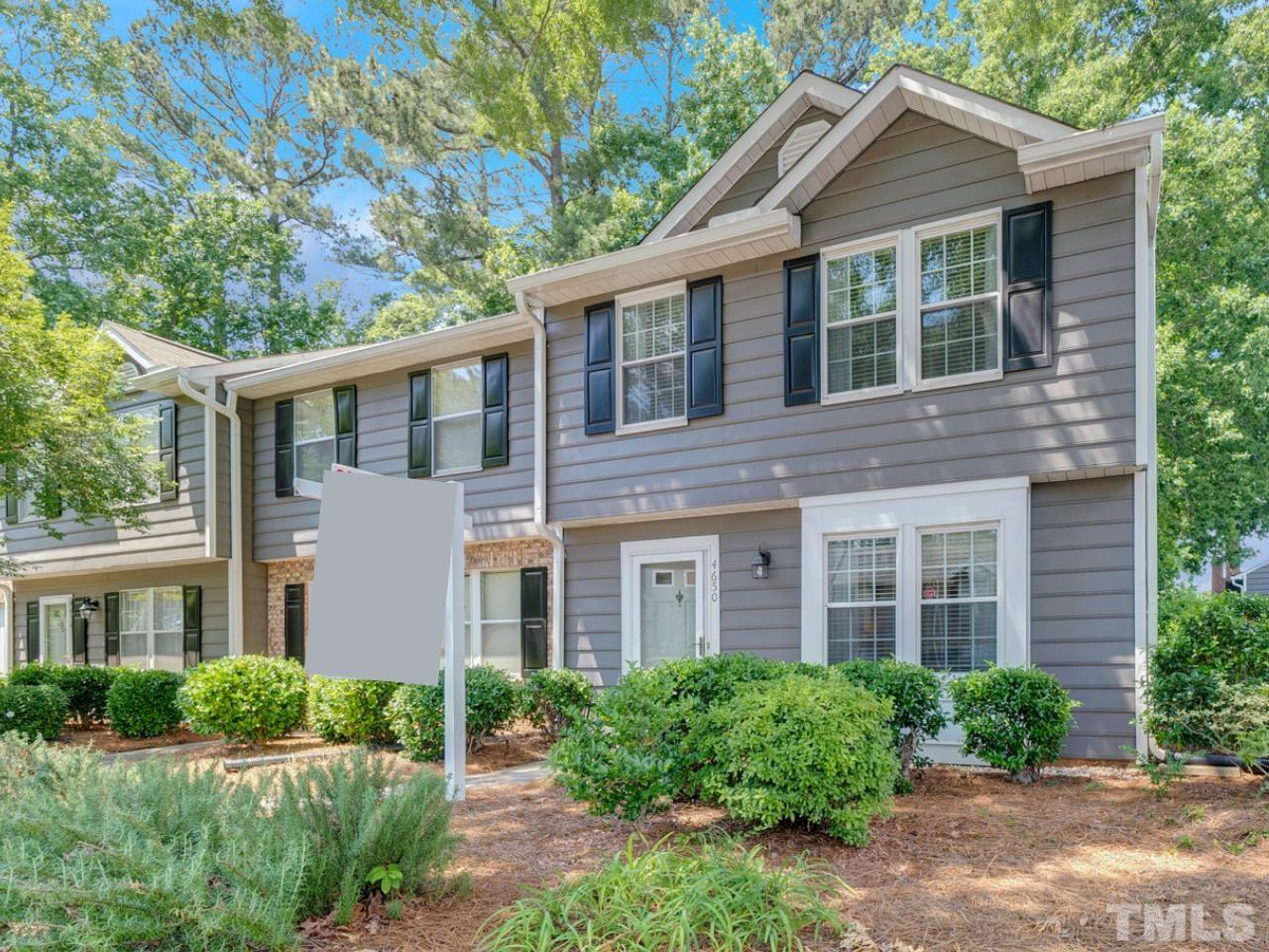 4650 Pine Trace Drive Raleigh, NC 27613 - Photo 2 of 26 a brick house with a yard plants and big trees