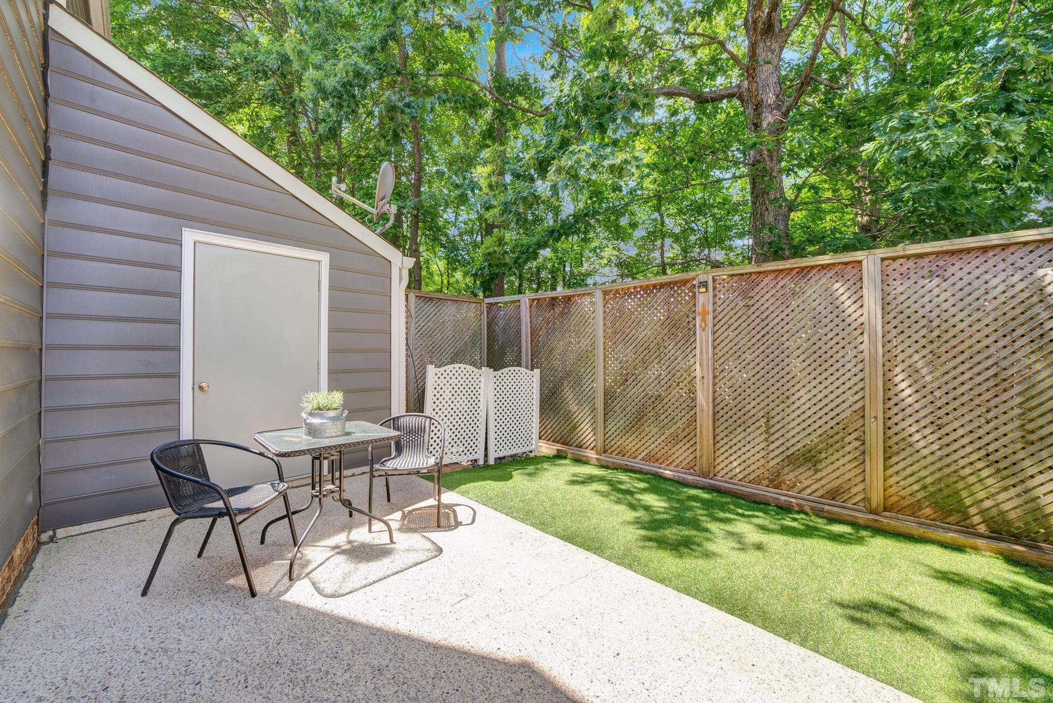 4650 Pine Trace Drive Raleigh, NC 27613 - Photo 23 of 26 a view of a chair and table in backyard of the house