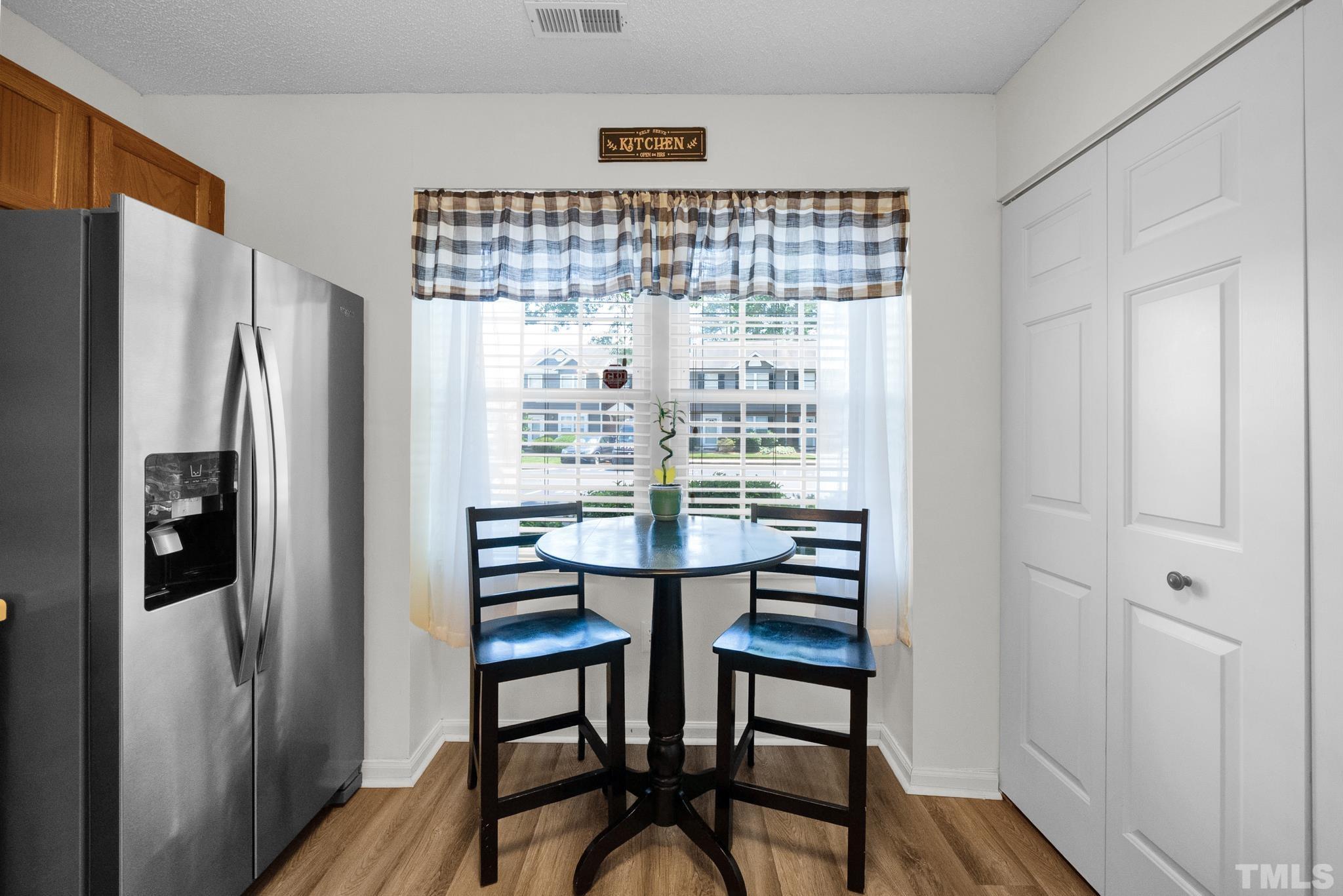 4650 Pine Trace Drive Raleigh, NC 27613 - Photo 7 of 26 a view of a dining room with furniture window and refrigerator