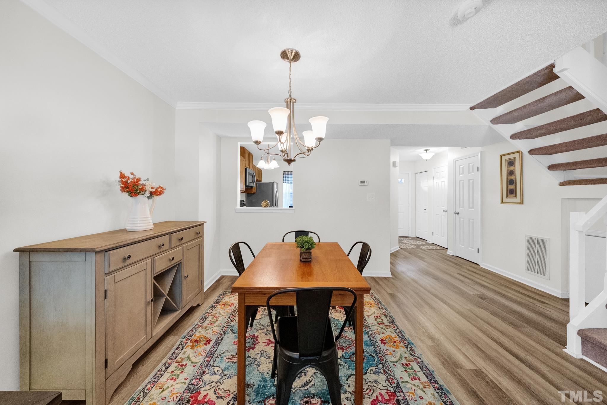 4650 Pine Trace Drive Raleigh, NC 27613 - Photo 10 of 26 a view of a dining room with furniture and chandelier