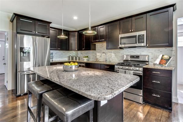 57 Creeley Road Belmont, MA 02478 - Photo 6 of 13 a kitchen with stainless steel appliances granite countertop a sink refrigerator and microwave