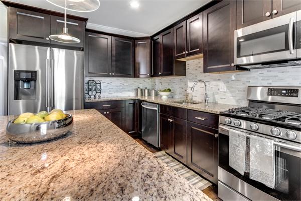 57 Creeley Road Belmont, MA 02478 - Photo 7 of 13 a kitchen with stainless steel appliances granite countertop a sink stove and refrigerator