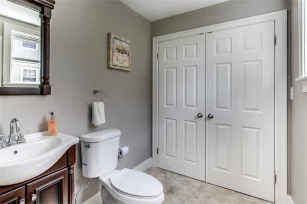 57 Creeley Road Belmont, MA 02478 - Photo 9 of 13 a white toilet sitting next to a bathroom sink