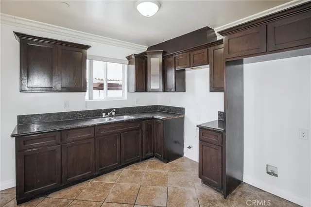 a kitchen with a sink and a refrigerator