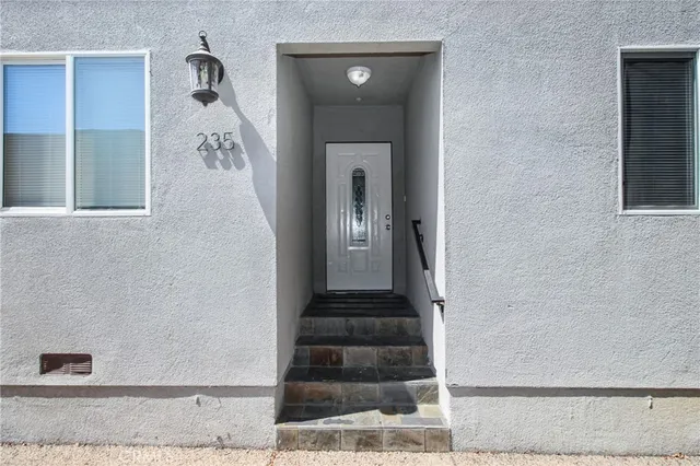 a view of a hallway with wooden floor and entryway