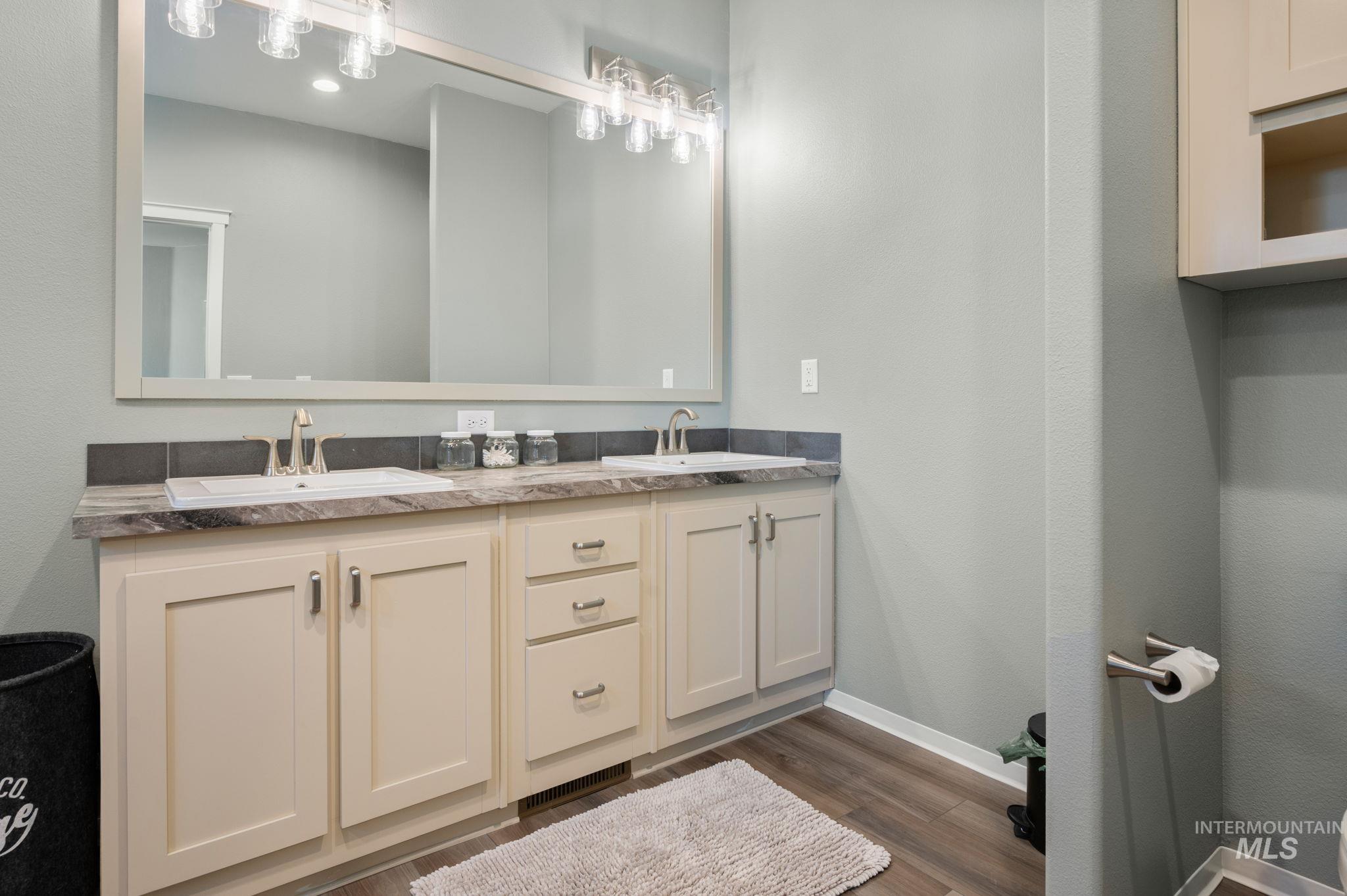 837 Burrell Avenue Lewiston, ID 83501 - Photo 12 of 32 Bathroom featuring double vanity and wood finished floors