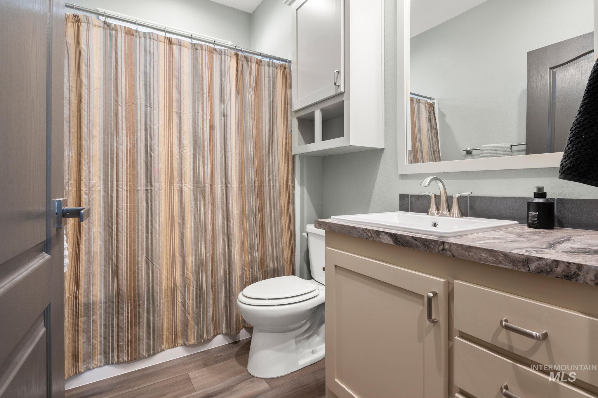 837 Burrell Avenue Lewiston, ID 83501 - Photo 18 of 32 Bathroom featuring wood finished floors and vanity