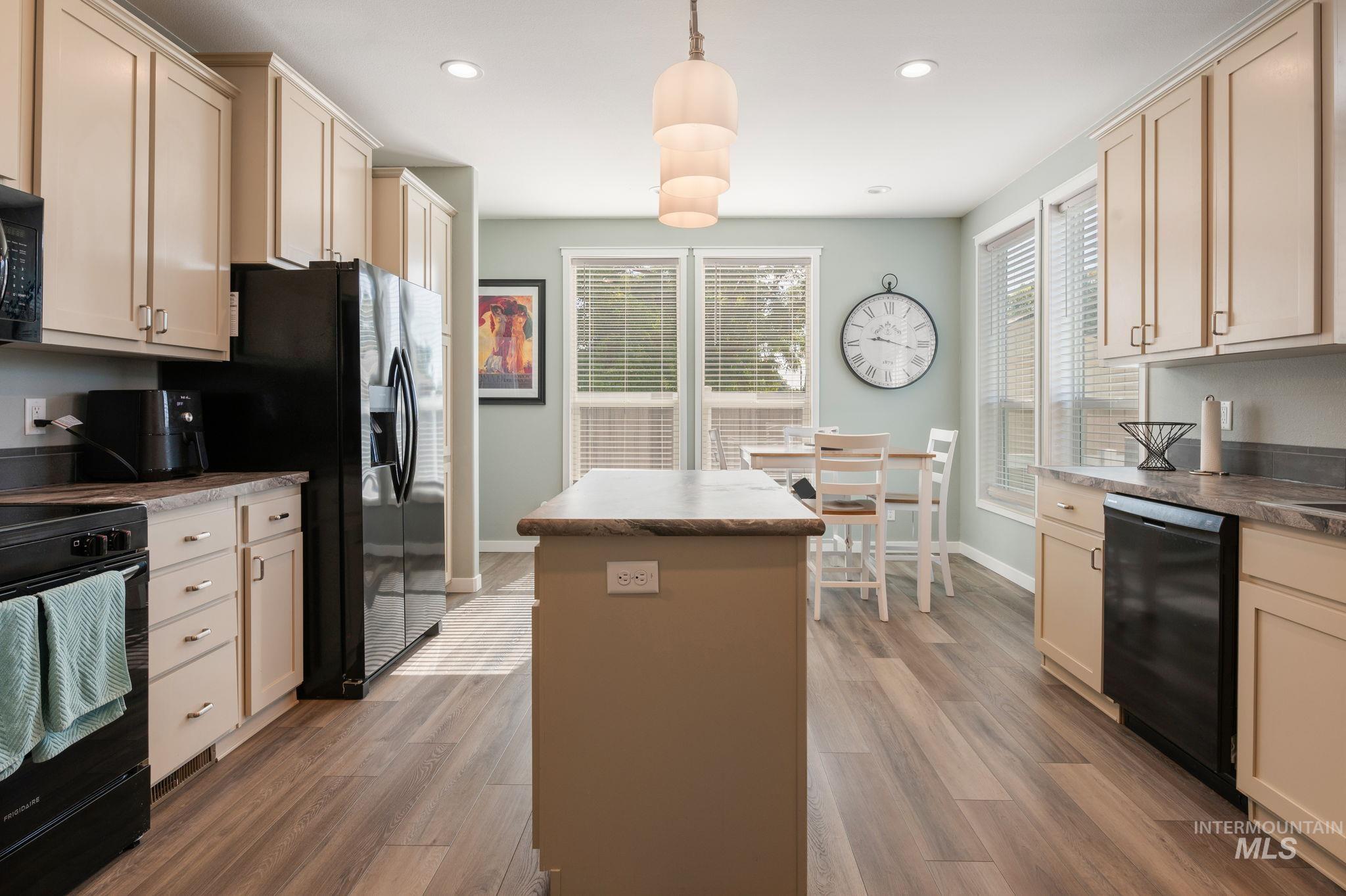 837 Burrell Avenue Lewiston, ID 83501 - Photo 22 of 32 Kitchen with a kitchen island, black appliances, light wood-type flooring, recessed lighting, and pendant lighting